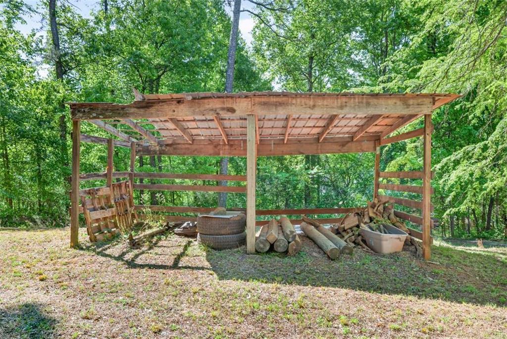 386 Ridgewood Drive Pendergrass, GA 30567 - Photo 34 of 50 a backyard of a house with table and chairs