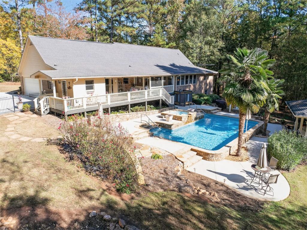 2150 Oglesby Bridge Road Southwest Conyers, GA 30094 - Photo 101 of 113 a view of a house with swimming pool and sitting area