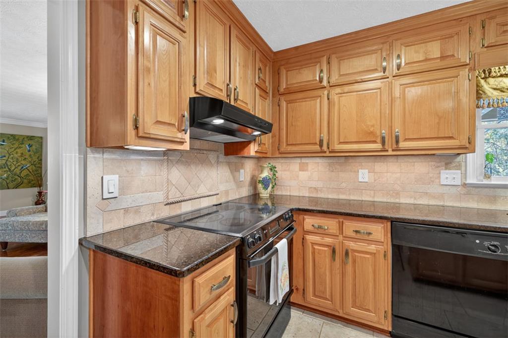 2150 Oglesby Bridge Road Southwest Conyers, GA 30094 - Photo 18 of 113 a kitchen with stainless steel appliances granite countertop a sink a stove and a microwave