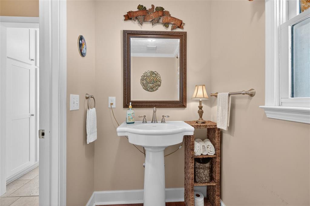 2150 Oglesby Bridge Road Southwest Conyers, GA 30094 - Photo 30 of 113 a bathroom with a sink a mirror and shower