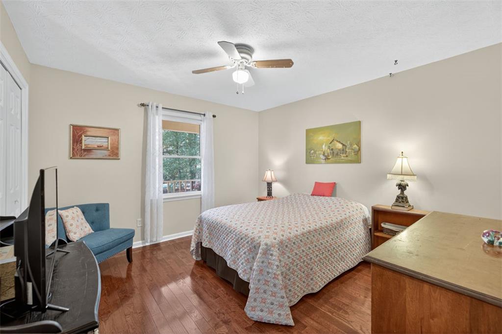 2150 Oglesby Bridge Road Southwest Conyers, GA 30094 - Photo 33 of 113 a bedroom with a bed and wooden floor