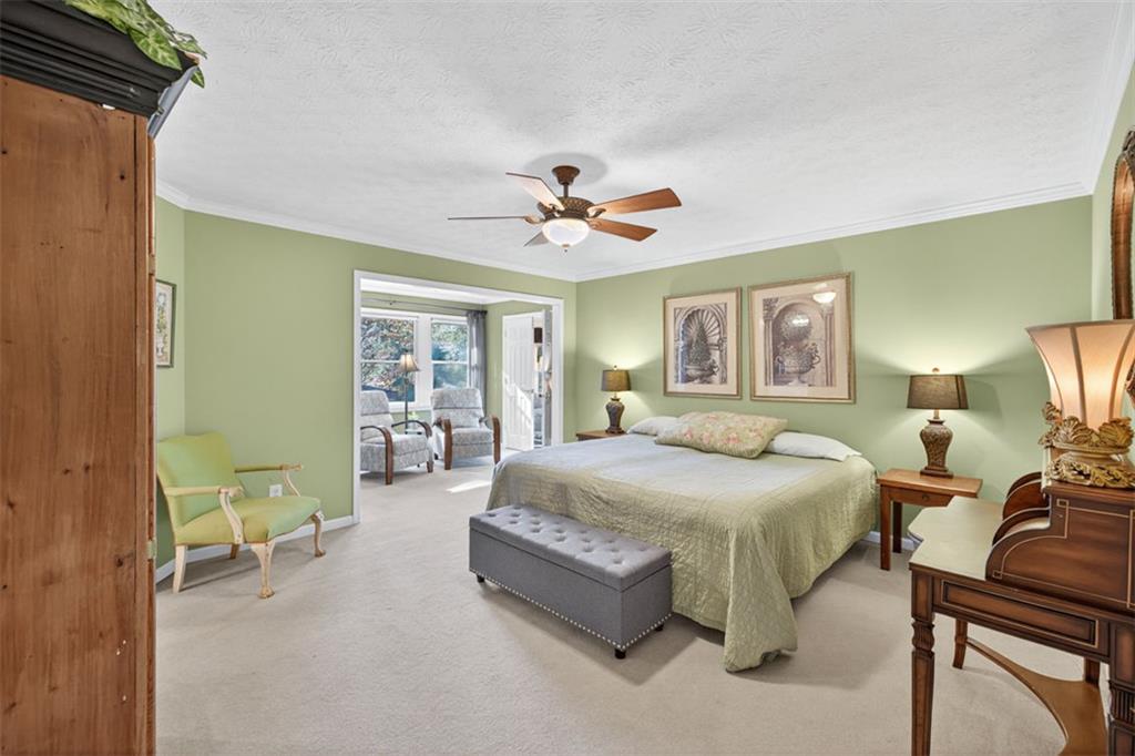 2150 Oglesby Bridge Road Southwest Conyers, GA 30094 - Photo 36 of 113 a spacious bedroom with a bed and a chandelier