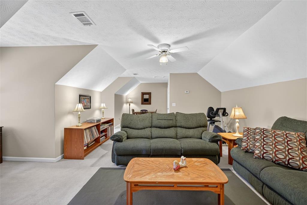 2150 Oglesby Bridge Road Southwest Conyers, GA 30094 - Photo 47 of 113 a living room with furniture and a ceiling fan