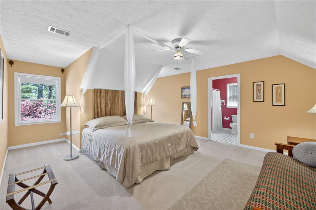 2150 Oglesby Bridge Road Southwest Conyers, GA 30094 - Photo 49 of 113 a spacious bedroom with a bed and dresser