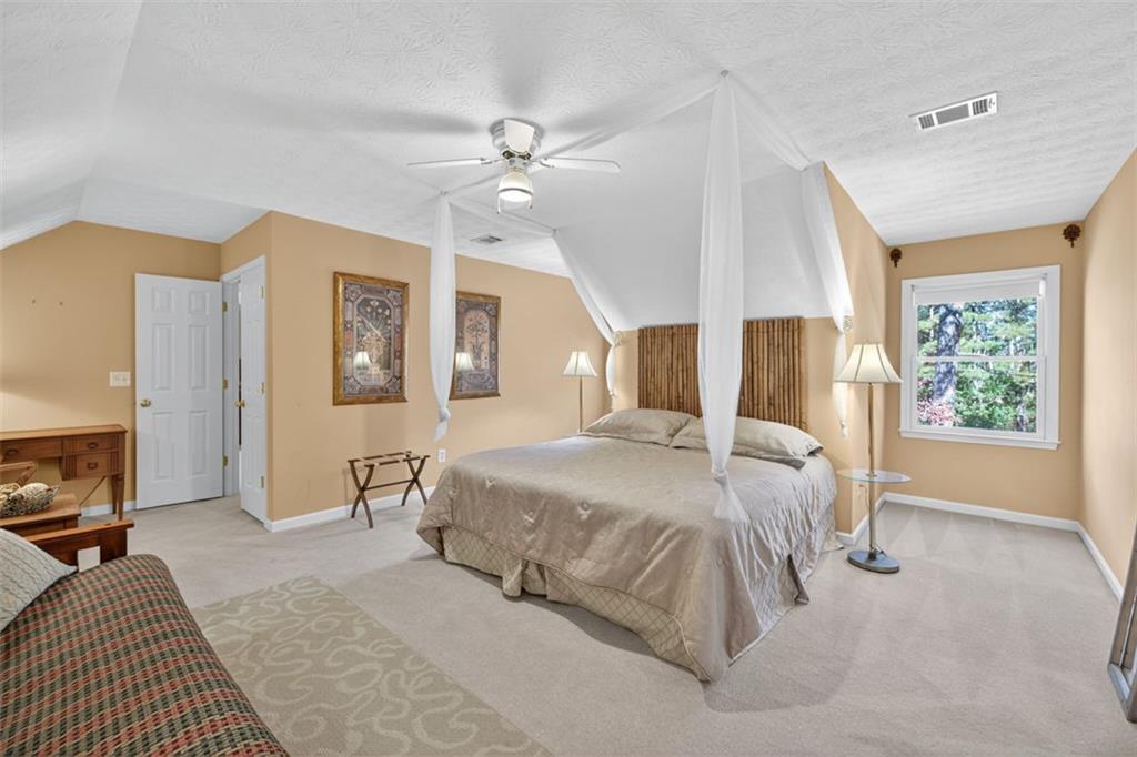 2150 Oglesby Bridge Road Southwest Conyers, GA 30094 - Photo 51 of 113 a bedroom with a large bed and a tv