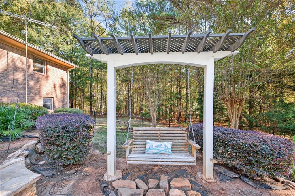 2150 Oglesby Bridge Road Southwest Conyers, GA 30094 - Photo 67 of 113 a front view of a house with garden