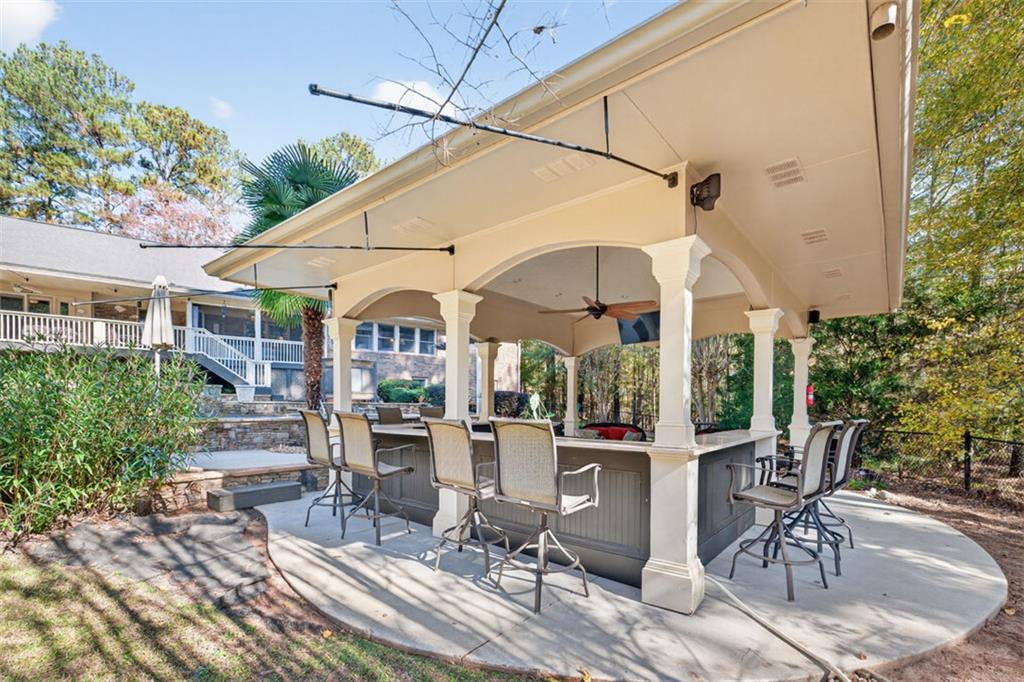 2150 Oglesby Bridge Road Southwest Conyers, GA 30094 - Photo 78 of 113 a view of a patio with a table and chairs under an umbrella