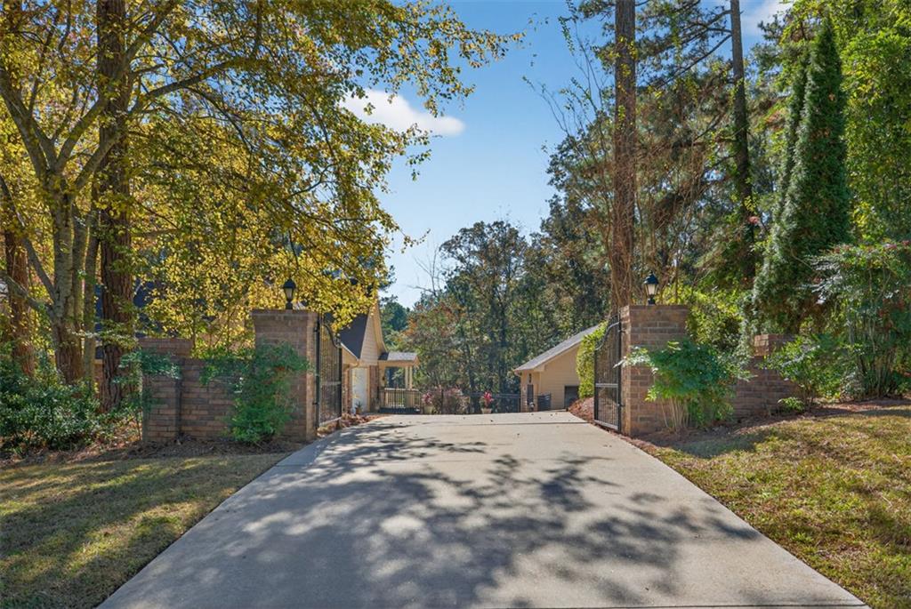 2150 Oglesby Bridge Road Southwest Conyers, GA 30094 - Photo 92 of 113 a view of a house with a tree in the background