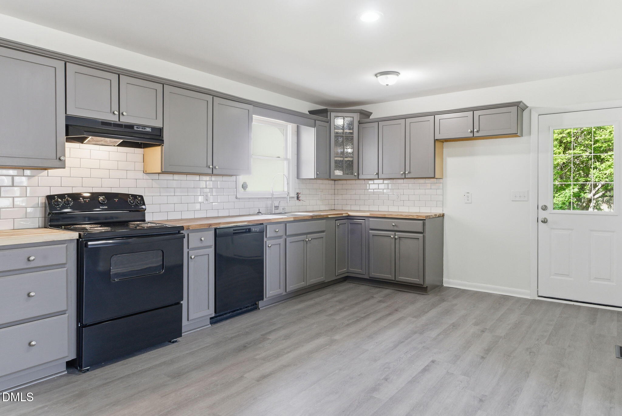 945 Old School Road Four Oaks, NC 27524 - Photo 9 of 37 a kitchen with stainless steel appliances granite countertop a sink cabinets and wooden floor