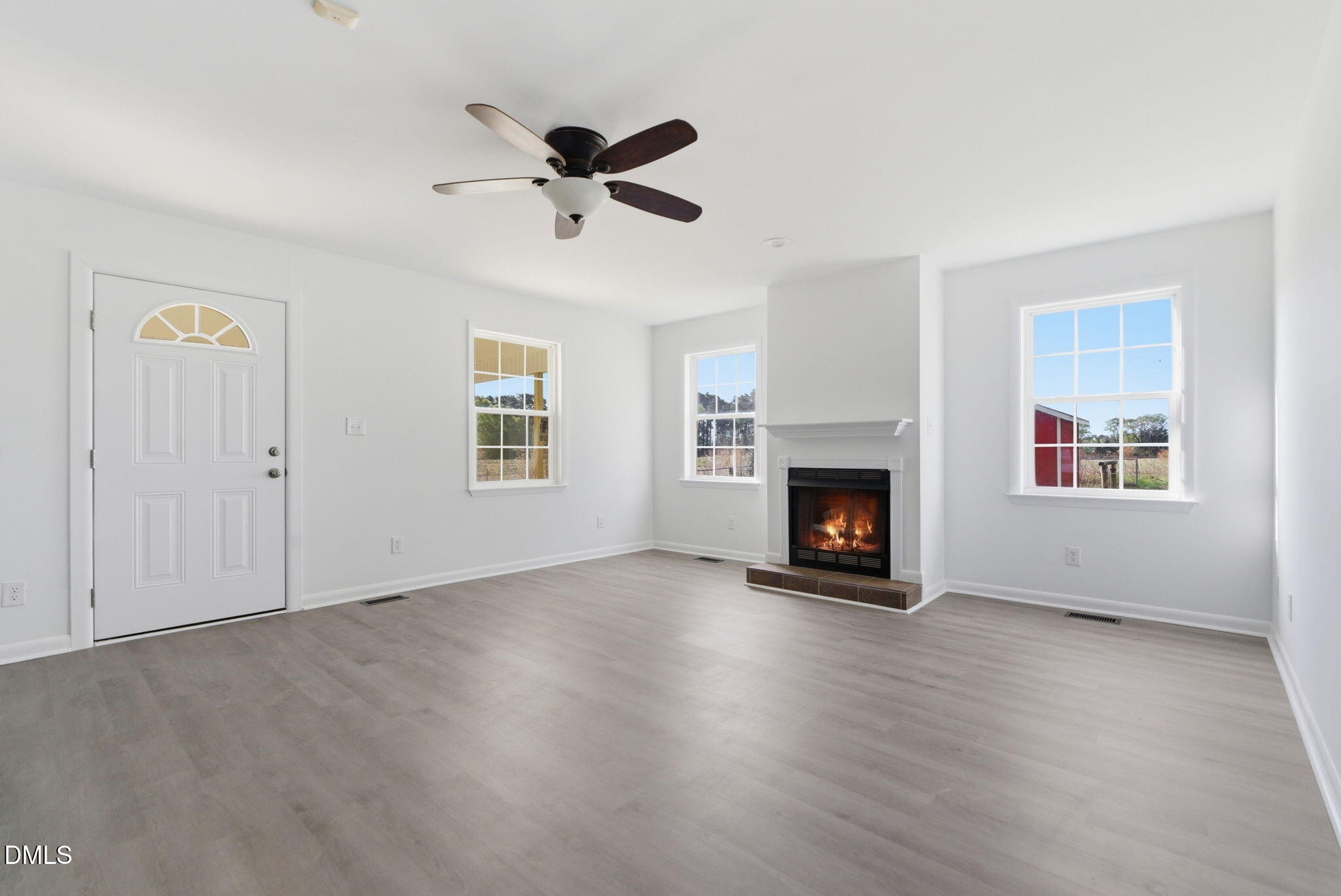 945 Old School Road Four Oaks, NC 27524 - Photo 14 of 37 a view of an empty room with window and fire place