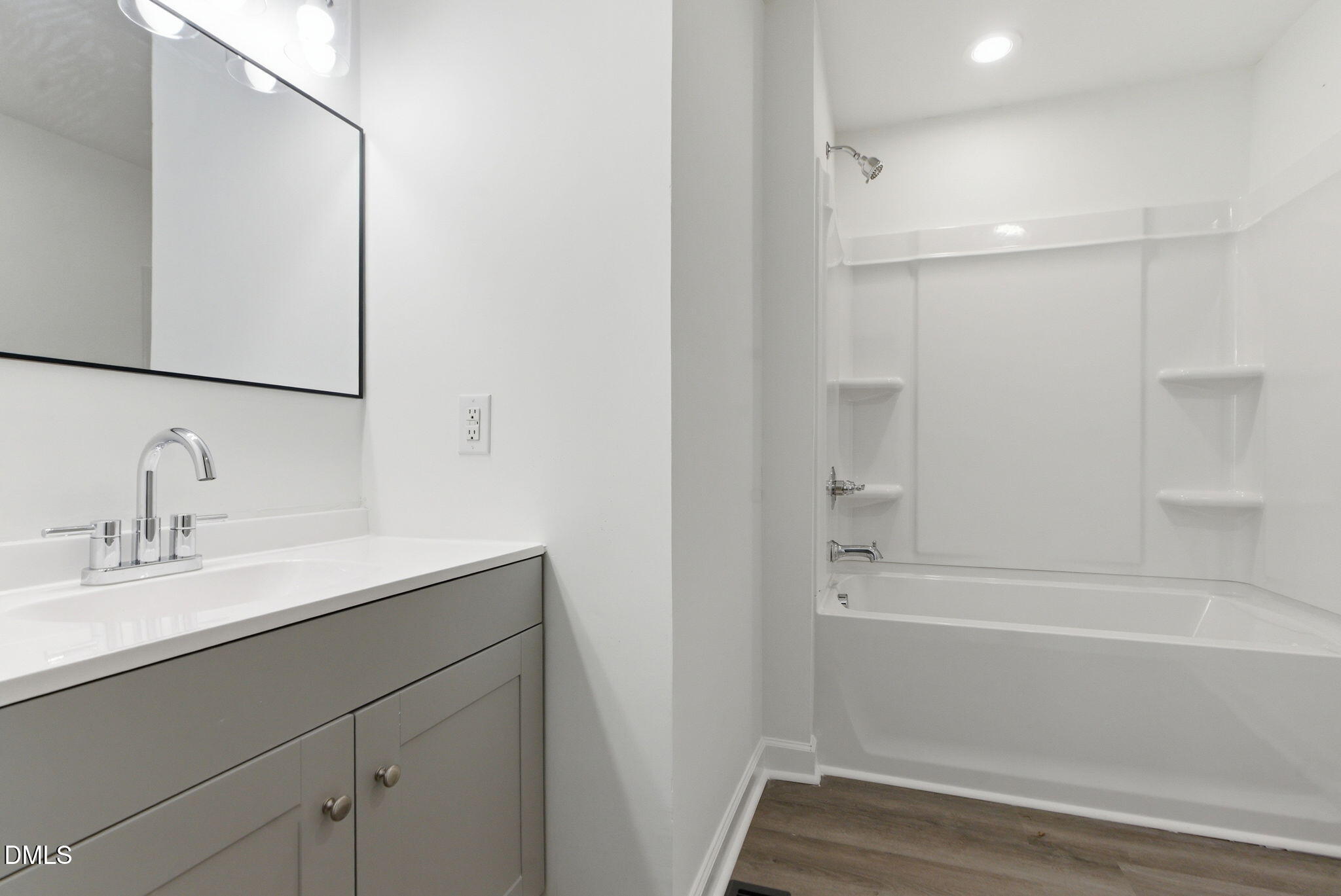 945 Old School Road Four Oaks, NC 27524 - Photo 16 of 37 a bathroom with a sink and a mirror