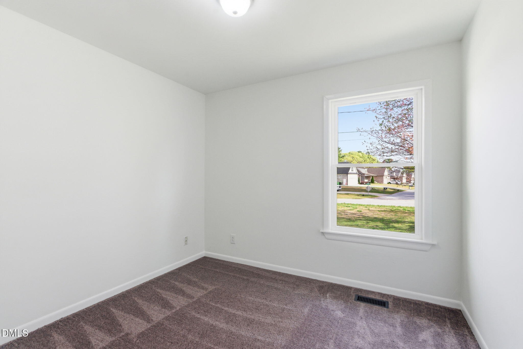 945 Old School Road Four Oaks, NC 27524 - Photo 18 of 37 an empty room with windows
