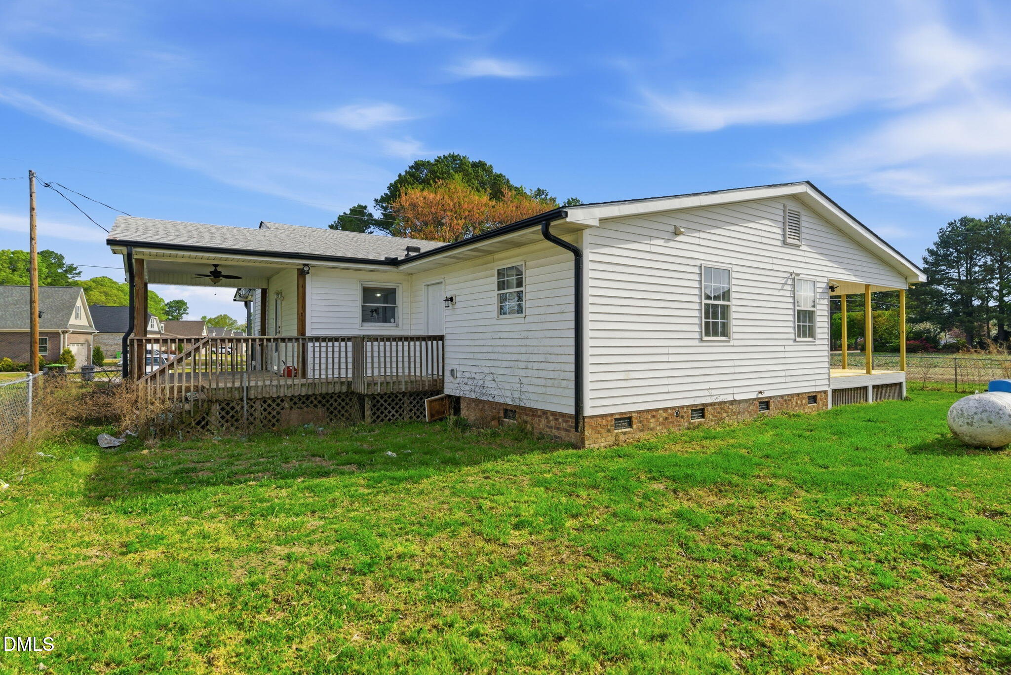 945 Old School Road Four Oaks, NC 27524 - Photo 28 of 37 a view of backyard of house with deck and entertaining space