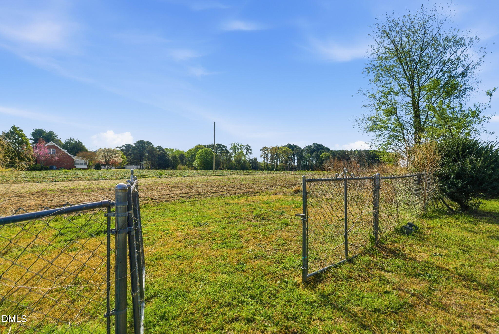 945 Old School Road Four Oaks, NC 27524 - Photo 31 of 37 a view of a lake with a floor to ceiling window next to a yard