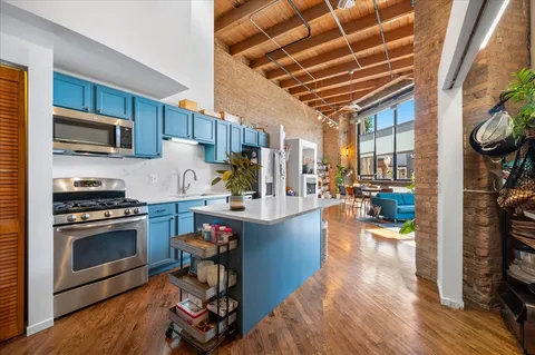 a kitchen with stainless steel appliances granite countertop a stove and a refrigerator