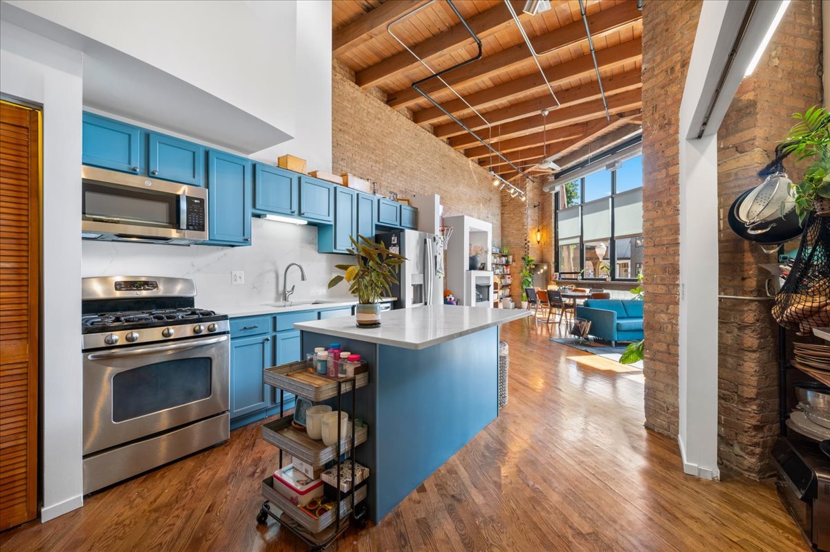 2161 North California Avenue, Unit 105 Chicago, IL 60647 - Photo 13 of 27 a kitchen with stainless steel appliances granite countertop a stove and a refrigerator