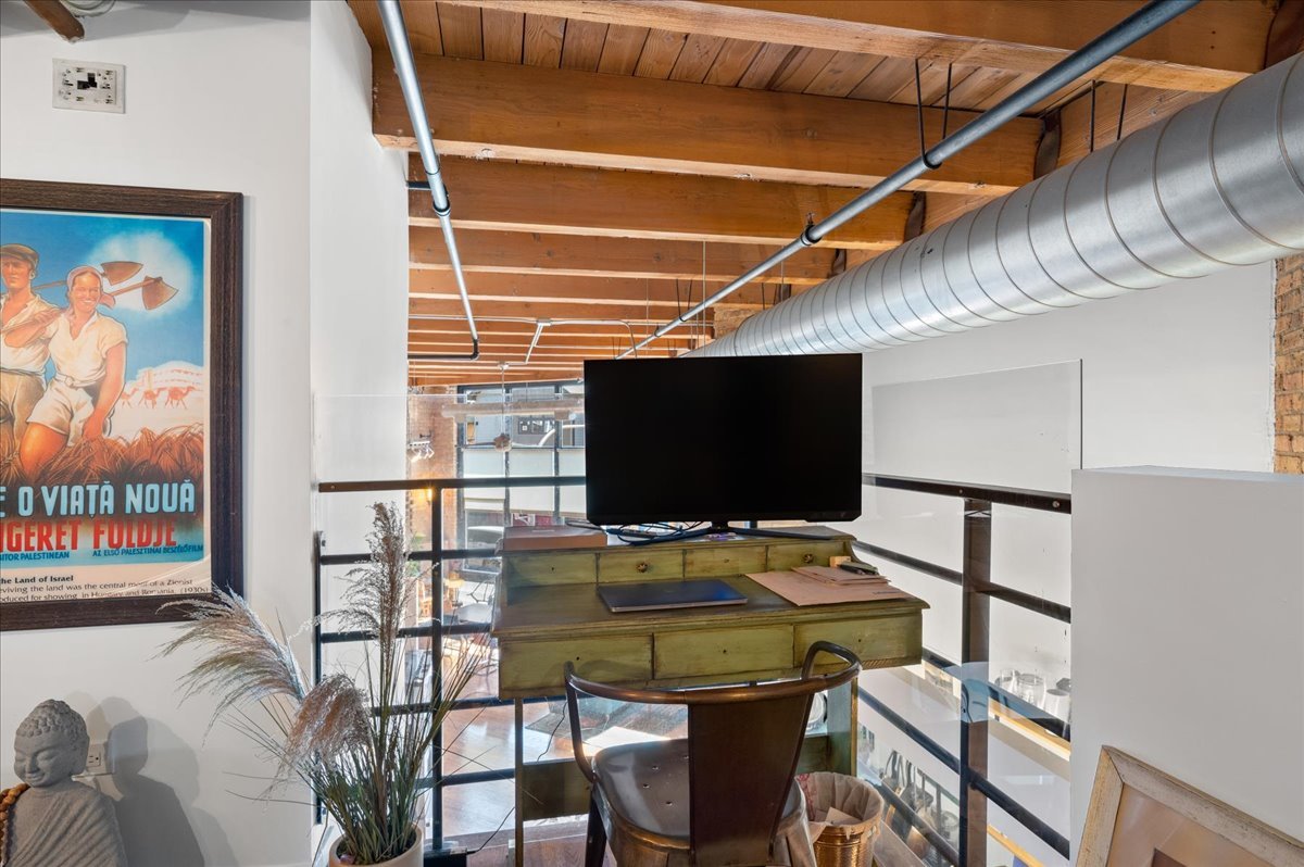 2161 North California Avenue, Unit 105 Chicago, IL 60647 - Photo 18 of 27 a room with furniture and a flat screen tv