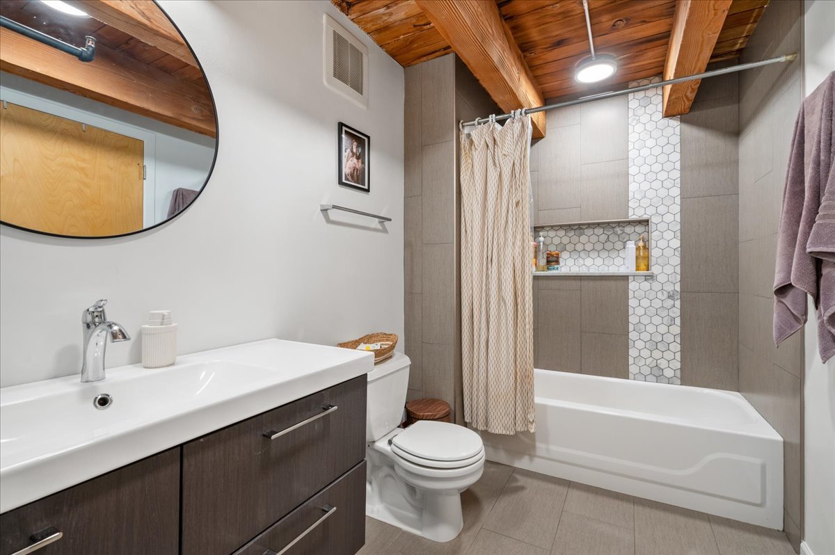 2161 North California Avenue, Unit 105 Chicago, IL 60647 - Photo 20 of 27 a bathroom with a sink toilet and shower