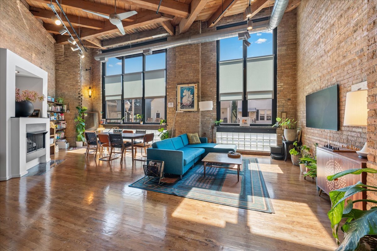 2161 North California Avenue, Unit 105 Chicago, IL 60647 - Photo 2 of 27 a living room with fireplace furniture and a large window