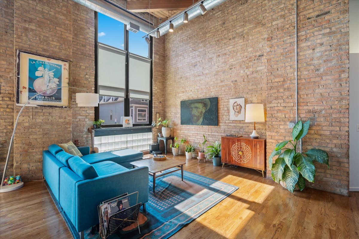 2161 North California Avenue, Unit 105 Chicago, IL 60647 - Photo 3 of 27 a living room with furniture fireplace and a potted plant