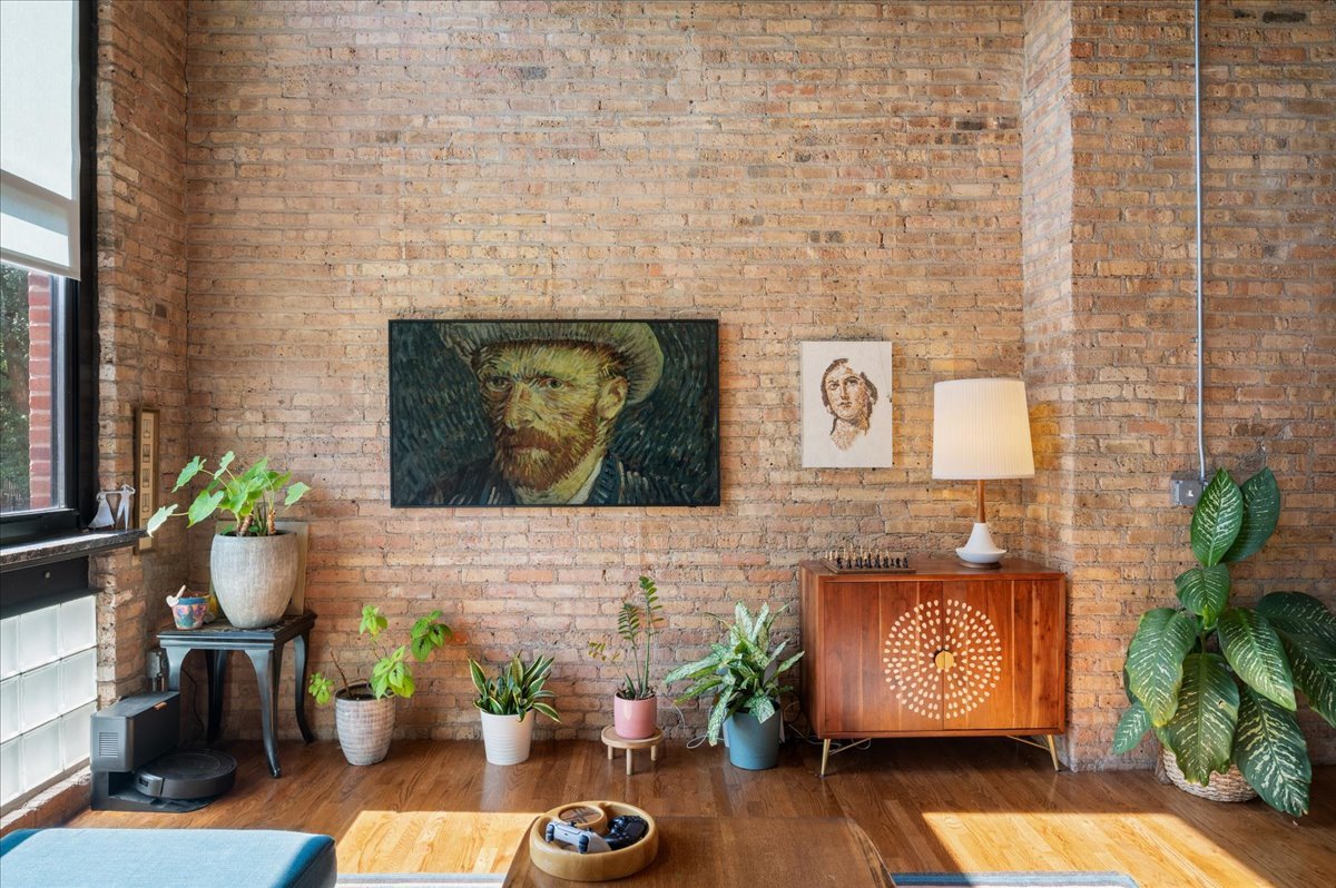 2161 North California Avenue, Unit 105 Chicago, IL 60647 - Photo 4 of 27 a stone wall with fireplace and potted plants