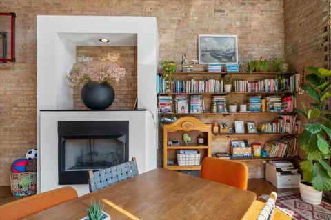 a living room with furniture a bookshelf and a fireplace