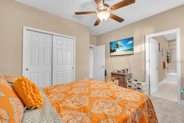 a bedroom with a large bed and a chandelier