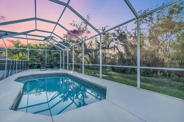 a view of a backyard with a swimming pool