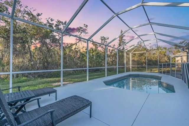 a view of a backyard with swimming pool