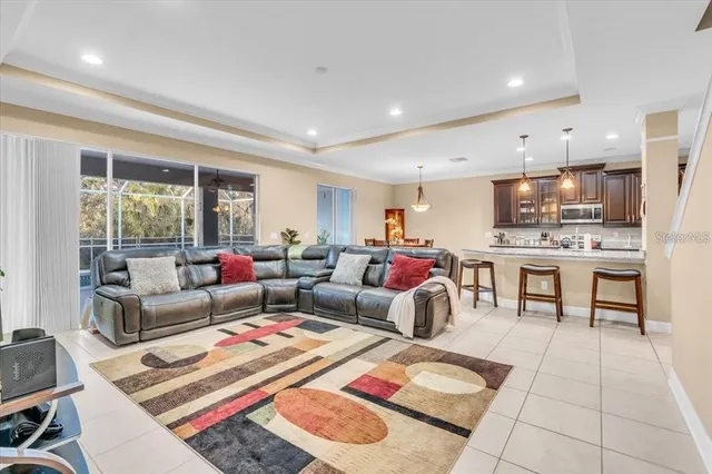 a living room with furniture and a open kitchen view