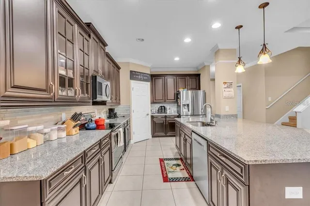 a kitchen with sink stove and cabinets