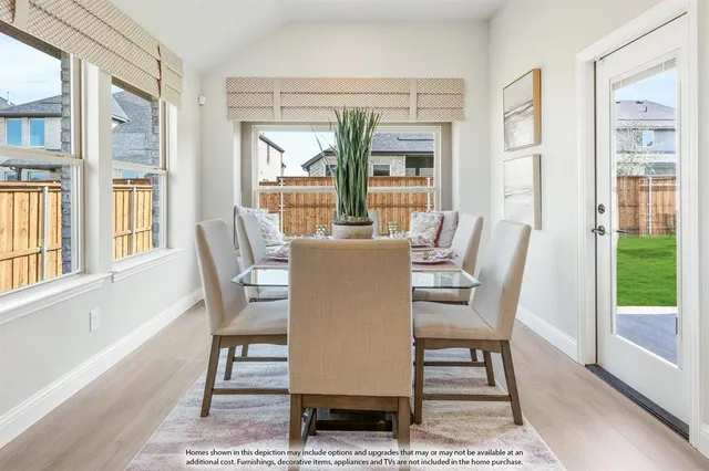 a dining room with furniture a rug and wooden floor