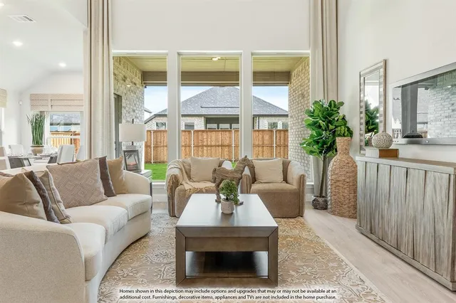 a living room with furniture a large window and a table