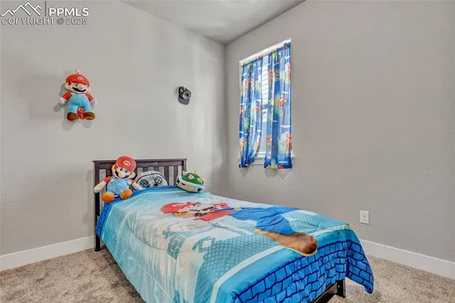 a bedroom with a bed a dresser and a book shelf