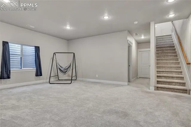 a view of an empty room with windows