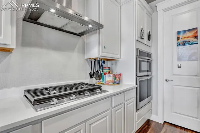 a stove top oven sitting inside of a kitchen