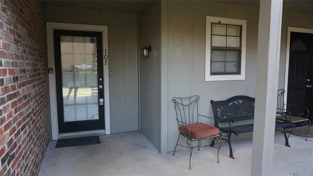 a balcony with table and chairs