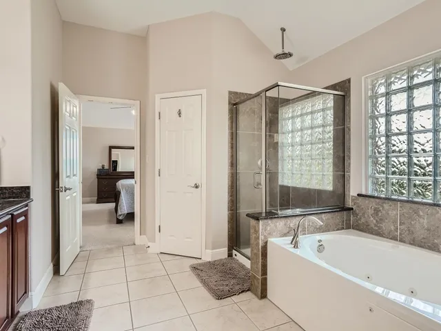 a bathroom with a bathtub and a shower