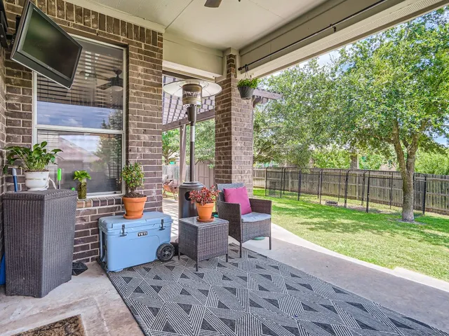 a backyard of a house with outdoor seating