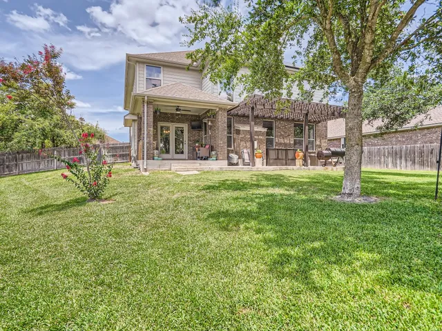 a view of a house with a yard and sitting area