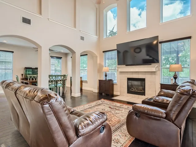 a living room with furniture fireplace and flat screen tv