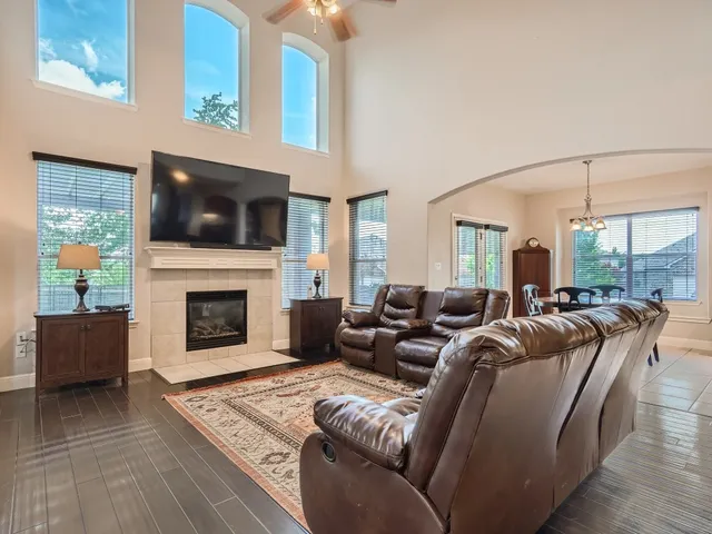 a living room with furniture a flat screen tv and a fireplace