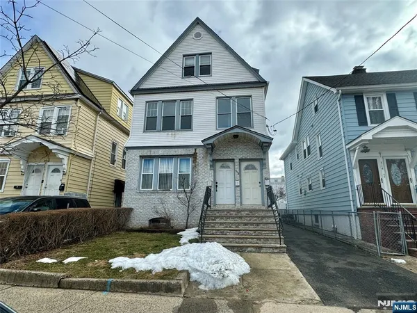 a front view of a house with a yard