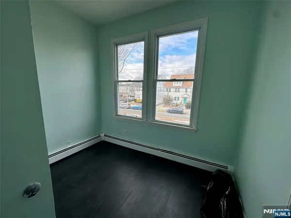 a view of room with window and hardwood floor