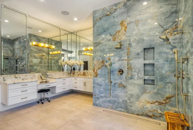 a bathroom with a mirror vanity and shower
