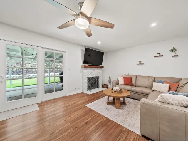 a living room with furniture a fireplace and a flat screen tv