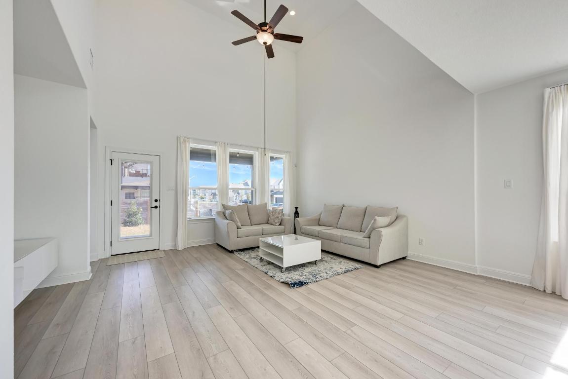316 Regatta Trail Leander, TX 78641 - Photo 10 of 40 a living room with furniture and a wooden floor