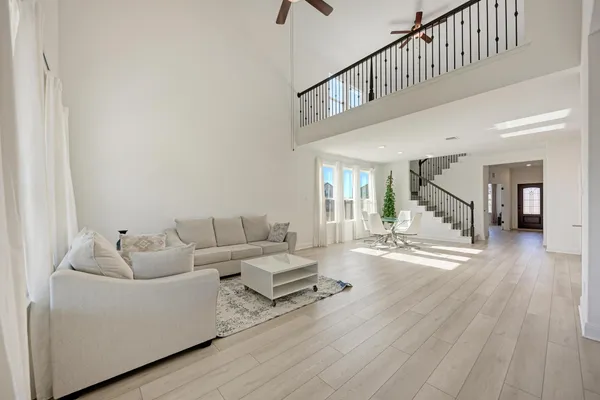 a living room with furniture and wooden floor