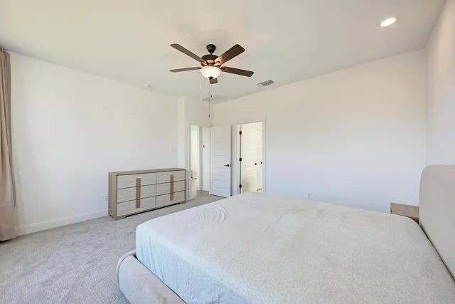 a living room with furniture and a view of kitchen