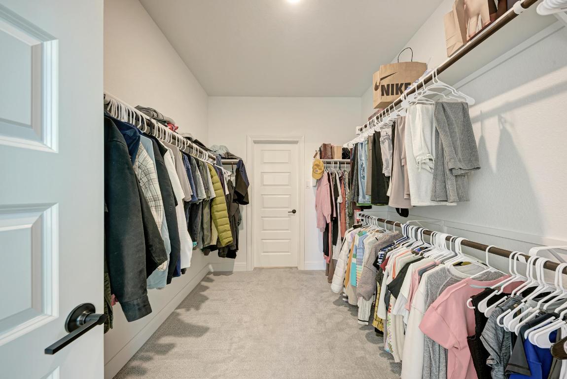 316 Regatta Trail Leander, TX 78641 - Photo 17 of 40 a view of walk in closet with clothes and shoes